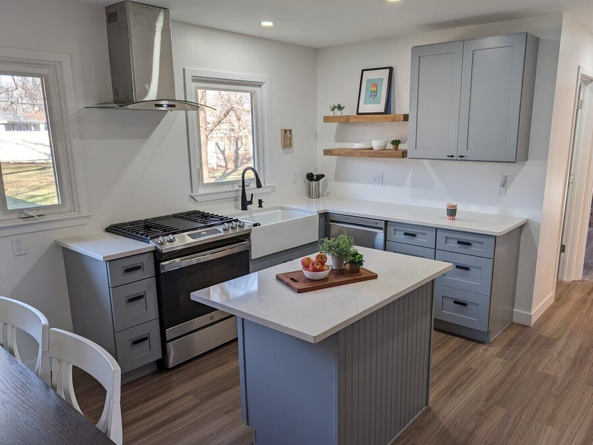 Modern kitchen remodel featuring gray cabinets and a farmhouse sink, completed by Clear Contractors in Northwest Indiana