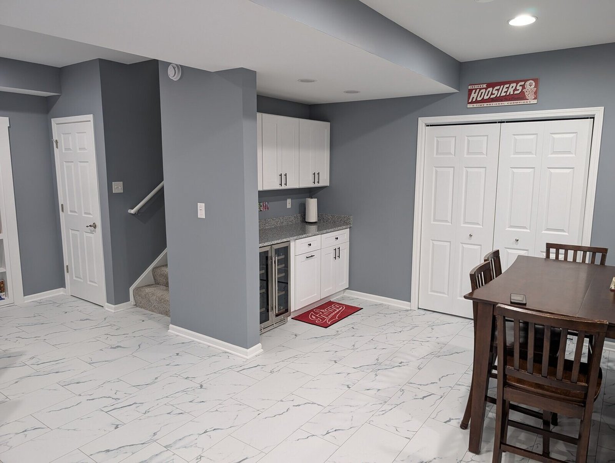 Newly renovated basement dining and kitchenette area with modern gray walls by Clear Contractors in Northwest Indiana