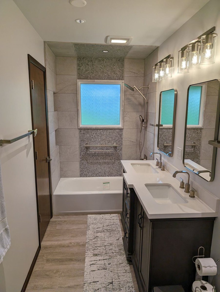 Elegant bathroom remodel with a double sink vanity and sleek tile accents by Clear Contractors in Northwest Indiana