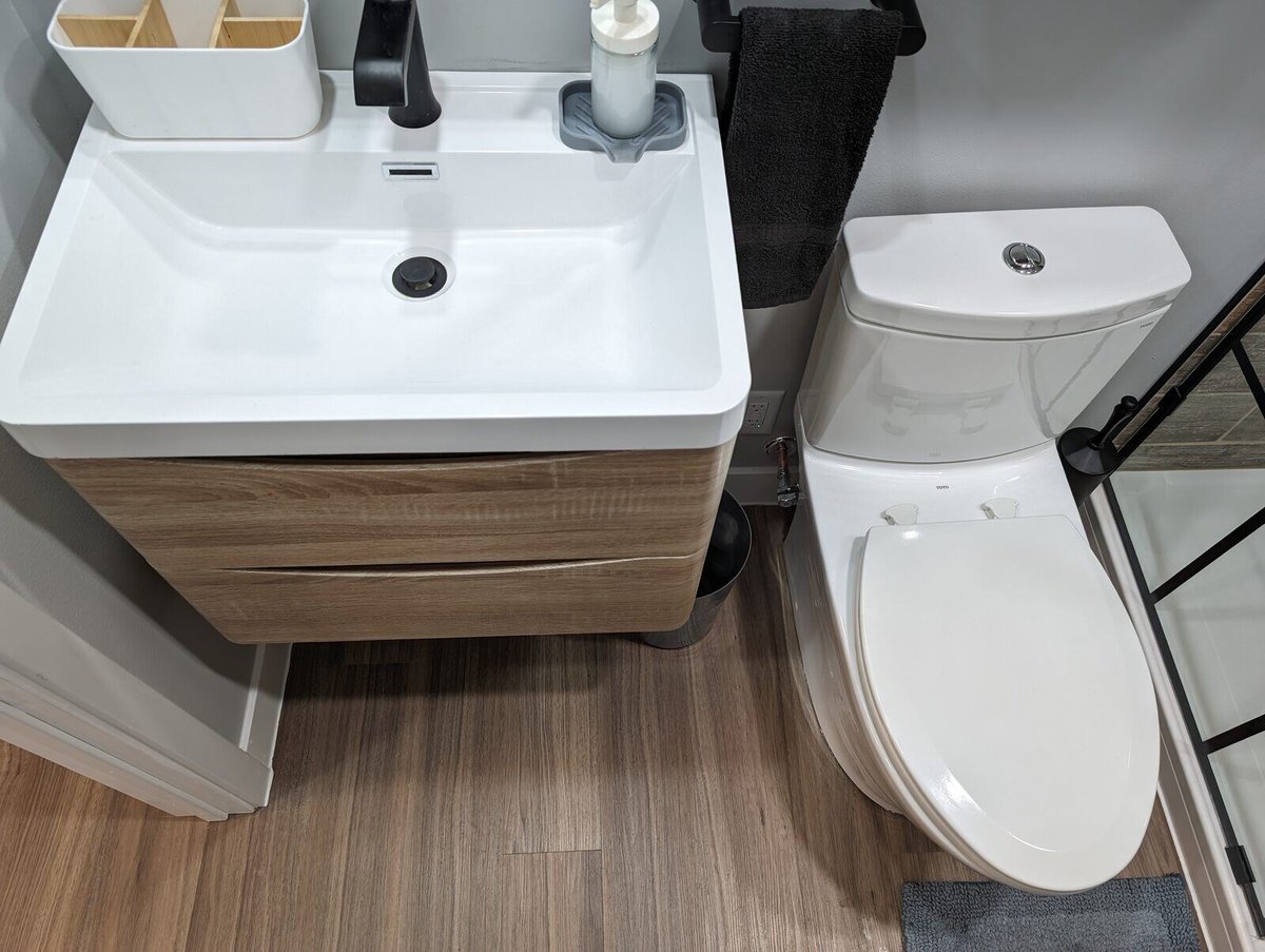 Top-down view of a floating vanity and modern toilet in a remodeled bathroom by Clear Contractors in Northwest Indiana